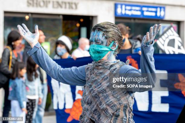 Protester dressed to represent pollution in the oceans takes part during the demonstration. The groups of Extinction Rebellion Marine, Ocean...