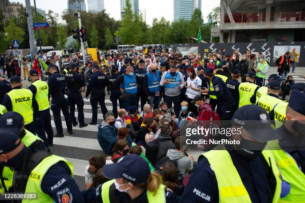 Climate activists are surrounded by police officers during a civil disobedience action on September 7, 2020 in Warsaw, Poland. A few hundred...