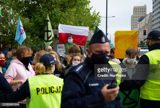 Extinction Rebellion activists are surrounded by police officers during a civil disobedience action on September 7, 2020 in Warsaw, Poland. A few...