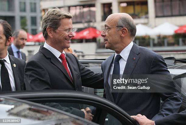 German Foreign Minister Guido Westerwelle bids farewell to French Foreign Minister Alain Juppe following talks on a boat on August 29, 2011 in...