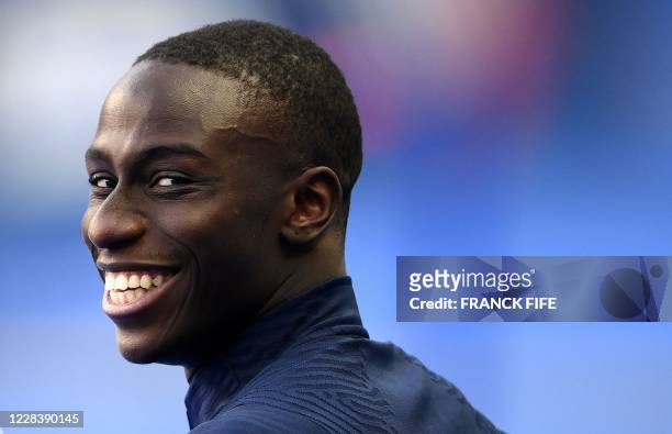 France's defender Ferland Mendy smiles ahead of a training session at the Stade de France in Saint-Denis, outside Paris, on September 7 on the eve of...