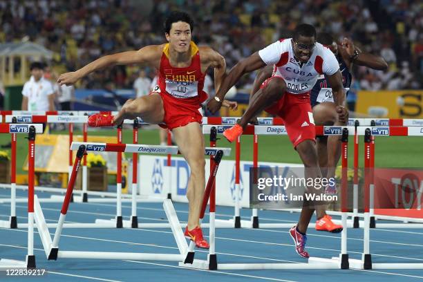 Xiang Liu of China and Dayron Robles of Cuba make contact after jumping over the 10th hurdle during the men's 110 metres hurdles final during day...