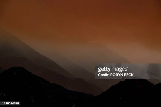 Smoke from the Bobcat fire rises in the Angeles National Forest above Duarte, California, about 27 miles northeast of Los Angeles, September 7, 2020....