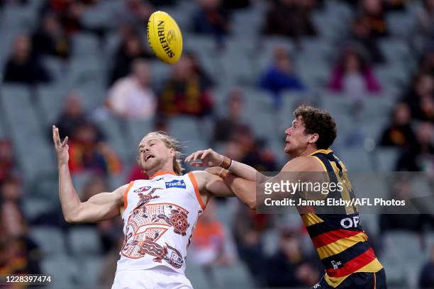 Harry Himmelberg of the Giants competes with Kyle Hartigan of the Crows during the 2020 AFL Round 16 match between the Adelaide Crows and the GWS...