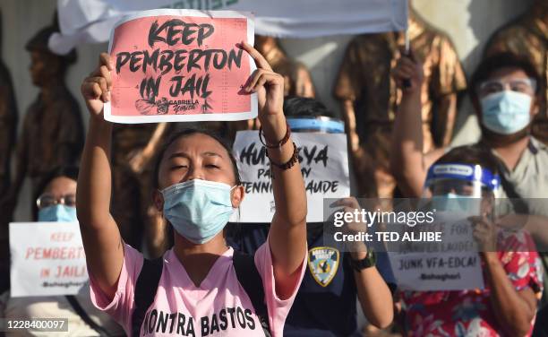 Demonstrators display placards to protest against Philippine President Rodrigo Duterte's decision to pardon US marine Lance corporal Joseph Scott...