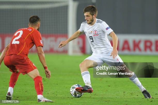 Giorgi Chakvetadze of Georgia dribbles with Egzon Bejtulai of North Macedonia against him during the UEFA Nations League group stage match between...