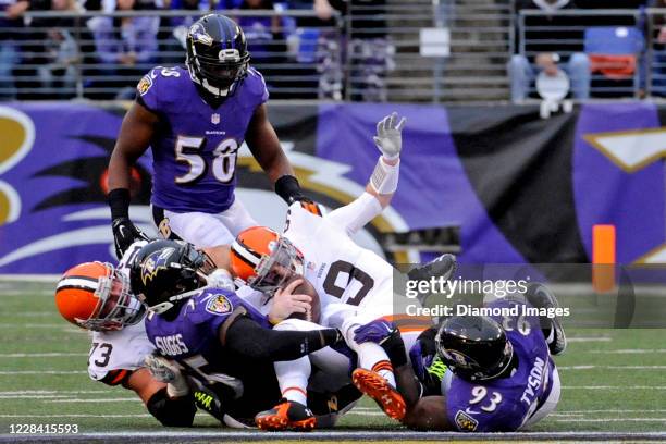 Quarterback Conner Shaw of the Cleveland Browns is sacked by linebacker Terrell Suggs and defensive end DeAngelo Tyson of the Baltimore Ravens in the...