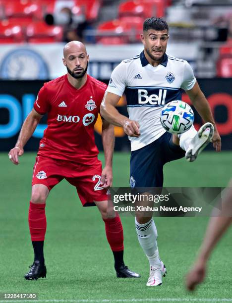 Sept. 5, 2020 -- Toronto FC's Laurent Ciman L vies with Vancouver Whitecaps FC's Lucas Cavallini during the 2020 Major League Soccer match between...