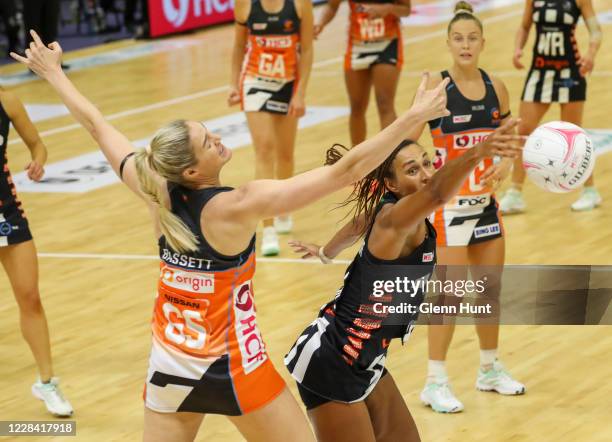 Caitlin Bassett of the Giants and Geva Mentor CBE of the Magpies compete for the ball during the round 11 Super Netball match between the Giants and...