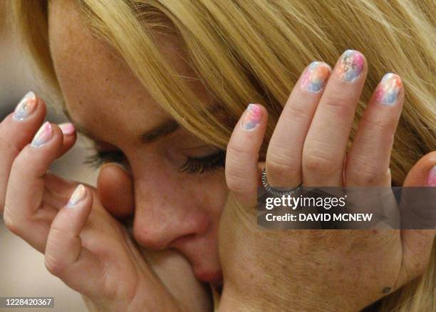 Lindsay Lohan cries as she is sentenced to 90 days jail by Judge Marsha Revel during her hearing at the Beverly Hills Courthouse on July 6, 2010. She...