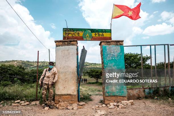 An armed member of the community security stands in front of a school where a polling station is located during Tigrays regional elections, in the...