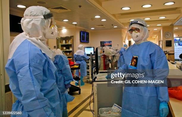 Medical staff work at the COVID-19 isolation ward of Meir Medical Center in Kfar Saba, near the Israeli coastal city of Tel Aviv, on September 9,...