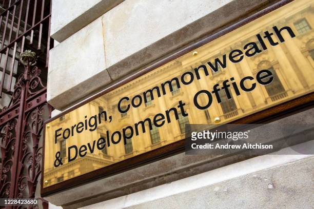 The Foreign and Commonwealth Office brass plaque sign outside the office building on King Charles Street on the 8th of September 2020 in Westminster,...