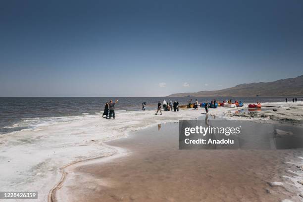 People visit the Lake of Urmia in the northwest of Iran, which had been shrinking in one of the worst ecological disasters of the past 25 years,...