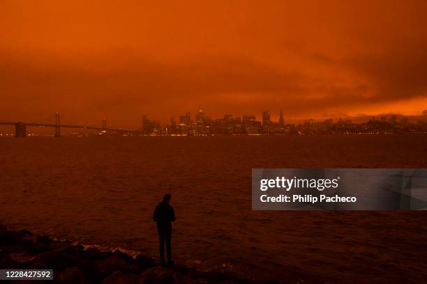 David Ren of Berkeley, California takes in the view as smoke from various wildfires burning across Northern California mixes with the marine layer,...