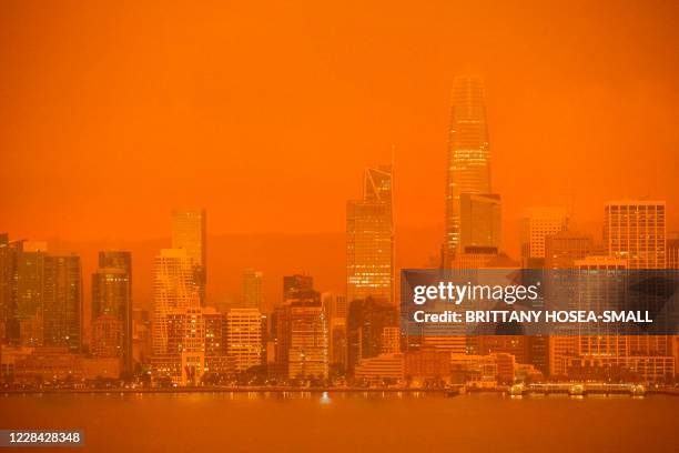 The San Francisco skyline is obscured in orange smoke and haze as their seen from Treasure Island in San Francisco, California on September 9, 2020....