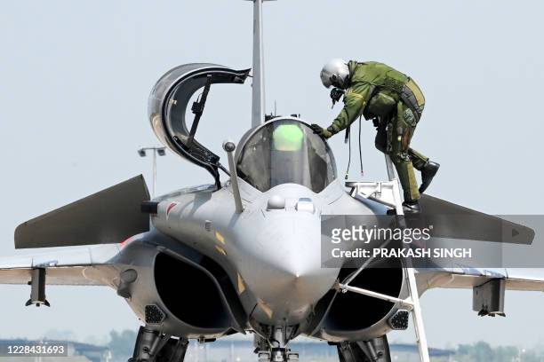 An Indian Air Force pilot gets out of the cockpit of Rafale jet after a flight during an induction ceremony at the Ambala Air Force Station in Ambala...