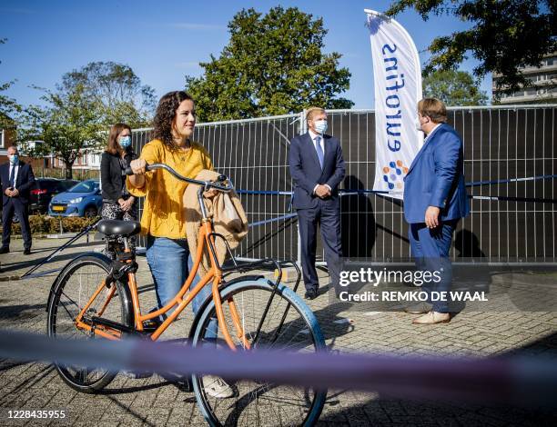 Netherland's King Willem-Alexander speaks with an official as he visits coronavirus testing site in Leiderdorp, The Netherlands on September 10,...