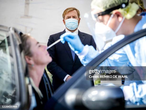 Netherland's King Willem-Alexander looks on as he visits a coronavirus test site in Leiderdorp, The Netherlands on September 10, 2020. - In the...