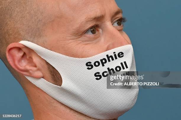 Film producer fabian Gasmia wears a face mask with the name of executed German anti-Nazi activist Sophie Scholl during a photocall for the film "Und...