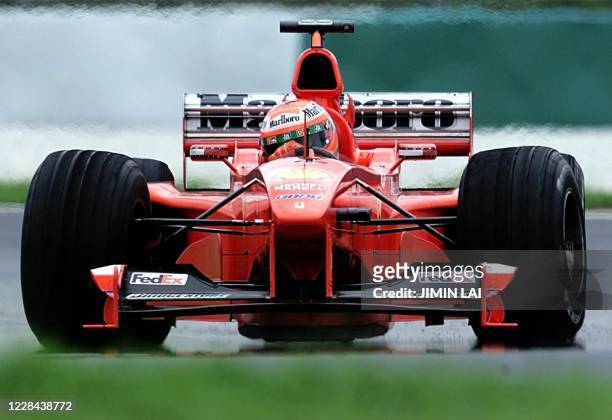 Ferrari Formula One driver Eddie Irvine of Northern Ireland negotiates a corner at the Sepang Formula One Circuit during the first timed practice for...