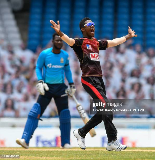 Akeal Hosein of Trinbago Knight Riders dismisses Darren Sammy of St Lucia Zouks during the Hero Caribbean Premier League Final match 33 between...