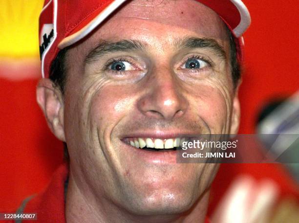 Irish Ferrari Formula One driver Eddie Irvine smiles during a press conference at the Pan Pacific Hotel in Sepang, Malaysia 13 October 1999. Irvine...