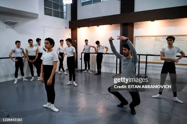 Male youngsters take part in a ballet class at Uruguay's Escuela Nacional de Danza in Montevideo on September 2, 2020. - Uruguayan footballer Edinson...