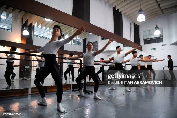 Male youngsters take part in a ballet class at Uruguay's Escuela Nacional de Danza in Montevideo on September 2, 2020. - Uruguayan footballer Edinson...