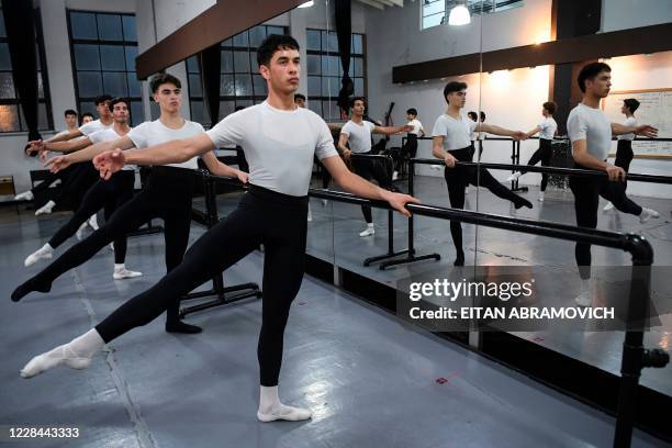 Male youngsters take part in a ballet class at Uruguay's Escuela Nacional de Danza in Montevideo on September 2, 2020. - Uruguayan footballer Edinson...