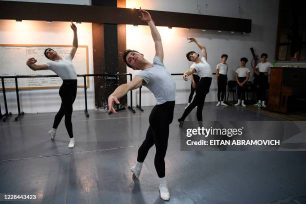 Male youngsters take part in a ballet class at Uruguay's Escuela Nacional de Danza in Montevideo on September 2, 2020. - Uruguayan footballer Edinson...