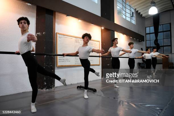 Male youngsters take part in a ballet class at Uruguay's Escuela Nacional de Danza in Montevideo on September 2, 2020. - Uruguayan footballer Edinson...