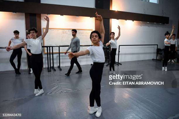 Male youngsters take part in a ballet class at Uruguay's Escuela Nacional de Danza in Montevideo on September 2, 2020. - Uruguayan footballer Edinson...