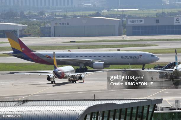 This picture taken on September 8, 2020 shows an aircraft of Asiana Airlines on the tarmac at Gimpo airport in Seoul. - A 2-billion-USD-plus deal for...