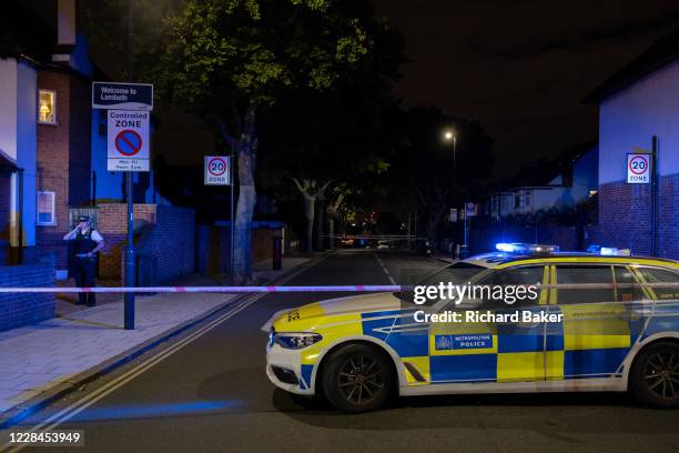 Met Police officer at the closed-off roads surrounding Herne Hill and Carnegie Library in Lambeth, after two people were reported shot in this...