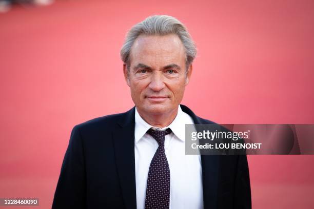 French actor Gilles Cohen poses as he arrives on the red carpet during the 46th US Film Festival of Deauville, Northwestern France, on September 11,...