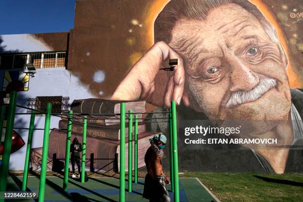 Men excercise in front of a mural by street artist Jose Gallino, depicting Uruguayan writer Mario Benedetti, at Plaza Zelmar Michellini, mentioned in...