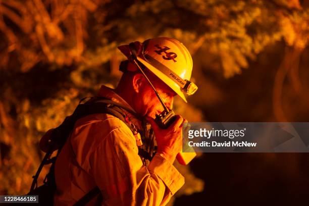 Los Angeles County firefighters, using only hand tools, keep fire from jumping a fire break at the Bobcat Fire in the Angeles National Forest on...
