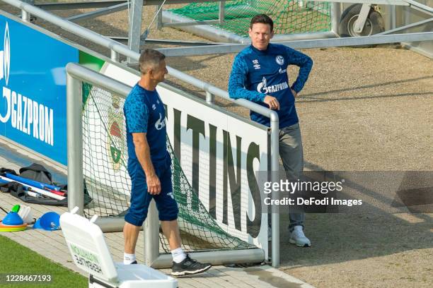 Athletic coach Werner Leuthard of FC Schalke 04 and Sascha Riether of FC Schalke 04 look on during the FC Schalke Training Session on September 11,...