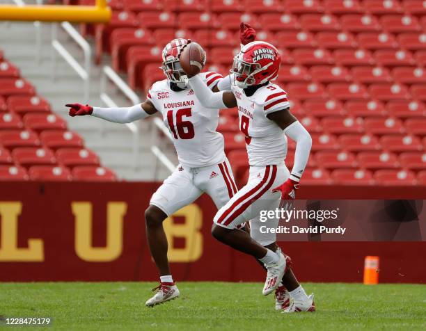 Safety Percy Butler of the Louisiana-Lafayette Ragin Cajuns celebrates with teammate cornerback Asjlin Washington of the Louisiana-Lafayette after...