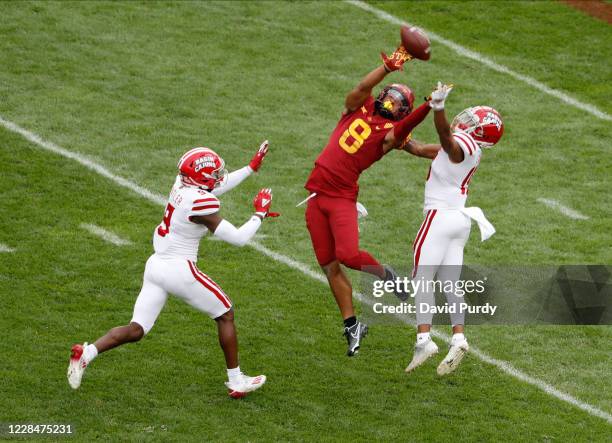 Wide receiver Xavier Hutchinson of the Iowa State Cyclones tries to pull in a pass as safety Percy Butler, and cornerback Eric Garror of the...