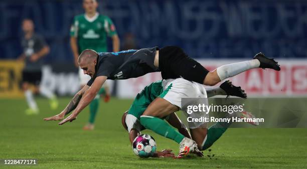 Dominik Bock of Jena and Oemer Toprak of Werder Bremen vie for the ball durng the DFB Cup first round match between FC Carl Zeiss Jena and Werder...