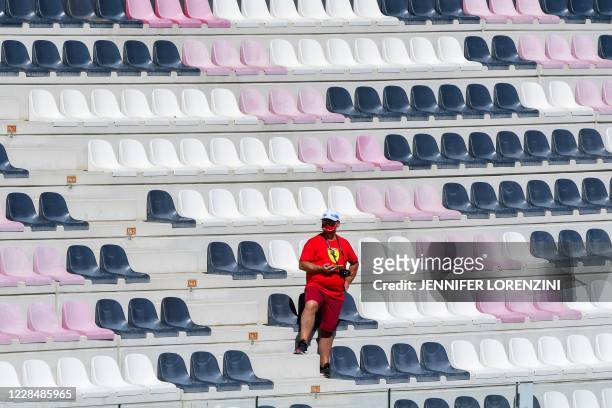Spectator waits for the start of the Tuscany Formula One Grand Prix at the Mugello circuit in Scarperia e San Piero on September 13, 2020.