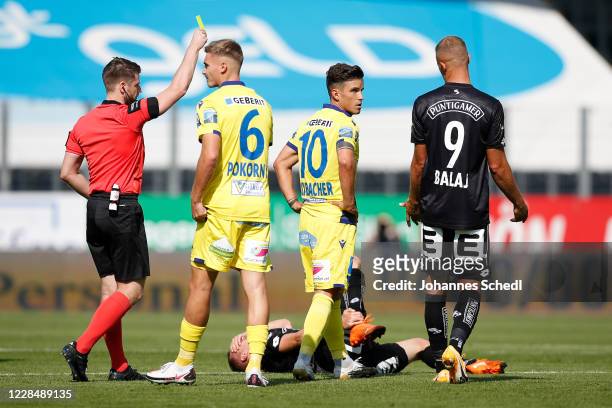 Referee Andreas Heiss, Peter Pokorny and Daniel Luxbacher of St. Poelten and Bekim Balaj of Sturm Graz during the tipico Bundesliga match between...