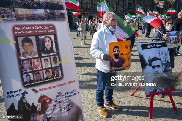 Man holds a portrait of Iranian wrestler Navid Afkari during a demonstration on the Dam Square in Amsterdam, the Netherlands, on September 13 against...