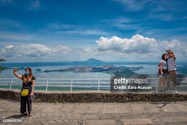 Local tourists take pictures with a view of Taal Volcano on September 13, 2020 in Tagaytay, Cavite province, Philippines. The Philippine government...