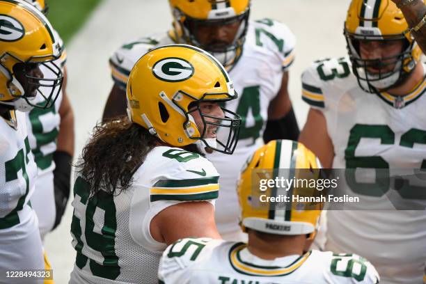 David Bakhtiari of the Green Bay Packers speaks to his teammates during warm ups before the game against the Minnesota Vikings at U.S. Bank Stadium...