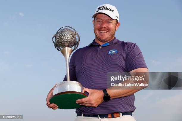 George Coetzee of South Africa holds the trophy following his win during Day Four of the Portugal Masters at Dom Pedro Victoria Golf Course on...