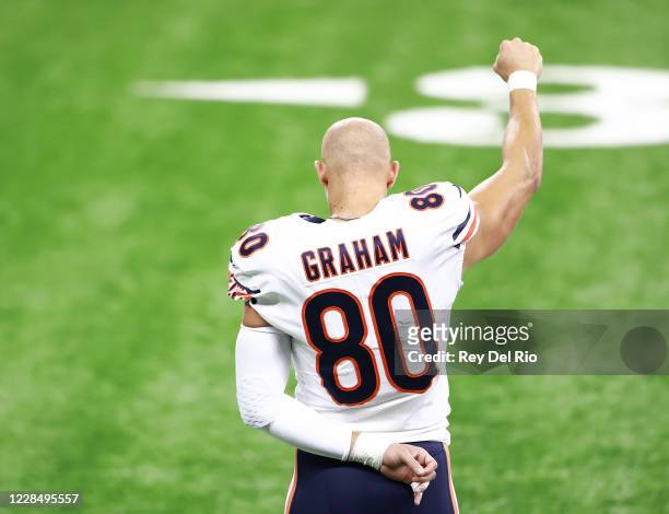 Jimmy Graham of the Chicago Bears raises his fist during the national anthem before the start of the game against the Detroit Lions at Ford Field on...