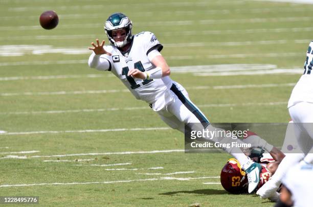 Carson Wentz of the Philadelphia Eagles throws a pass in the first quarter against the Washington Football Team at FedExField on September 13, 2020...